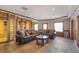 Basement lounge area with leather sofas and stone floor at 10385 Grande Vista Ct, Lone Tree, CO 80124