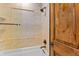 Bathroom features a tiled shower and decorative accent tile at 10385 Grande Vista Ct, Lone Tree, CO 80124