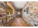 Stone hallway with hardwood floors and windows at 10385 Grande Vista Ct, Lone Tree, CO 80124