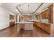 Gourmet kitchen with large island, custom cabinetry and hardwood floors at 10385 Grande Vista Ct, Lone Tree, CO 80124