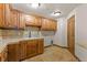 Laundry room with wooden cabinets and a utility sink at 10385 Grande Vista Ct, Lone Tree, CO 80124