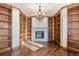 Library with built-in bookshelves, hardwood floors and a fireplace at 10385 Grande Vista Ct, Lone Tree, CO 80124