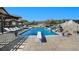 Inviting pool with lounge chairs and waterfall feature at 10385 Grande Vista Ct, Lone Tree, CO 80124