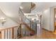 Elegant curved staircase with wooden railings and wrought-iron spindles at 10385 Grande Vista Ct, Lone Tree, CO 80124