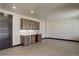 Finished basement with custom cabinetry, a sink, and tile floors, ideal for entertaining at 1778 Peak Loop, Broomfield, CO 80023
