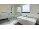 Elegant bathroom with a freestanding tub, glass enclosed shower, and modern fixtures with great natural light at 1778 Peak Loop, Broomfield, CO 80023