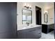 Double sink bathroom with stylish mirrors, sleek vanity with white countertops, and contemporary lighting at 1778 Peak Loop, Broomfield, CO 80023