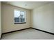 Bright, neutral bedroom with a large window, carpeted floor, and fresh contemporary design at 1778 Peak Loop, Broomfield, CO 80023