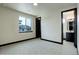 Cozy bedroom with en-suite bathroom, a large window, and neutral carpeting for comfort at 1778 Peak Loop, Broomfield, CO 80023