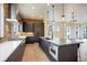 Open concept kitchen with a brick accent wall, stainless appliances, and a large island at 1778 Peak Loop, Broomfield, CO 80023