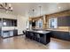 Gourmet kitchen with island seating, stainless steel appliances, and brick backsplash at 1778 Peak Loop, Broomfield, CO 80023