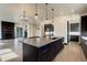 Spacious open-concept living area with a modern kitchen, fireplace, and hardwood floors at 1778 Peak Loop, Broomfield, CO 80023