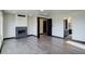 Bright living room with modern fireplace, neutral walls, and light wood floors, exuding contemporary elegance at 1778 Peak Loop, Broomfield, CO 80023