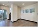 Bright living room with hardwood floors, black trim, and access to the outdoor balcony at 1778 Peak Loop, Broomfield, CO 80023