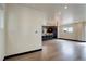 Open living space showcasing hardwood floors, with a view into the modern kitchen at 1778 Peak Loop, Broomfield, CO 80023