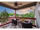 Charming balcony with checkered tile flooring, comfortable seating, and scenic views of the lush surroundings at 1300 W Caley Ave, Littleton, CO 80120