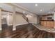 Spacious basement with hardwood-style floors and bar area with patterned tile at 1300 W Caley Ave, Littleton, CO 80120