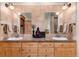 Bathroom with double vanity, a decorative plant, and great lighting creating a spa-like atmosphere at 1300 W Caley Ave, Littleton, CO 80120