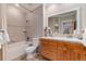 Bathroom featuring a single sink vanity with tiled countertop and a shower-tub combination at 1300 W Caley Ave, Littleton, CO 80120