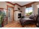 Sitting room featuring a fireplace, hardwood floors, and a lounge chair, creating a cozy space at 1300 W Caley Ave, Littleton, CO 80120