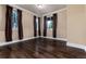 Bedroom featuring dark wood floors and multiple windows with curtains at 1300 W Caley Ave, Littleton, CO 80120