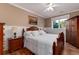 Cozy bedroom with hardwood floors, wainscoting, and a large window allowing plenty of natural light at 1300 W Caley Ave, Littleton, CO 80120