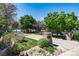 Stone pillars mark the entrance to this landscaped property with mature trees at 1300 W Caley Ave, Littleton, CO 80120