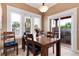 Dining room with a table and chairs, large windows, and a sliding glass door to outdoor grill at 1300 W Caley Ave, Littleton, CO 80120