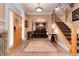 Inviting foyer with tile flooring, natural woodwork and staircase to the second floor at 1300 W Caley Ave, Littleton, CO 80120