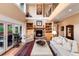 Cozy living room with fireplace, built-in bookshelves and floor to ceiling windows at 1300 W Caley Ave, Littleton, CO 80120