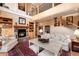 Comfortable living room featuring a stone fireplace, soaring ceilings and hardwood floors at 1300 W Caley Ave, Littleton, CO 80120