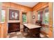 Cozy office space featuring wood paneling, large windows, and a marble-topped desk at 1300 W Caley Ave, Littleton, CO 80120