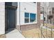 Modern home exterior with brick accents and a dark gray front door at 453 Interlocken Blvd # 102, Broomfield, CO 80021