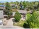 Aerial view of a home with well-maintained landscaping, a patio, and a driveway at 7414 S Monroe Ct, Centennial, CO 80122