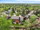 Aerial view of a home showcasing mature trees, landscaping, and a backyard patio at 7414 S Monroe Ct, Centennial, CO 80122