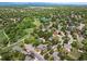 Panoramic aerial view of a suburban community with houses nestled among lush trees and green spaces at 7414 S Monroe Ct, Centennial, CO 80122