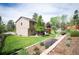 Well-maintained backyard with lush lawn, landscaping, and outdoor patio at 7414 S Monroe Ct, Centennial, CO 80122