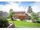 Spacious backyard featuring a pergola-covered patio, landscaping, and lush lawn at 7414 S Monroe Ct, Centennial, CO 80122