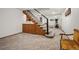 Finished basement featuring carpeted floors, stairs, and small sink with cabinets at 7414 S Monroe Ct, Centennial, CO 80122