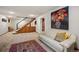 Spacious basement with a wet bar, carpeted floor, and comfortable white sofa at 7414 S Monroe Ct, Centennial, CO 80122