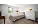 Bright bedroom featuring a window and chest of drawers at 7414 S Monroe Ct, Centennial, CO 80122