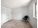 Bedroom featuring a dark chair, closet and a large window for natural light at 7414 S Monroe Ct, Centennial, CO 80122