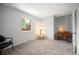 Blue bedroom with window view, side table, and small desk at 7414 S Monroe Ct, Centennial, CO 80122