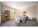 Cozy bedroom with a window view, complemented by a wicker shelf and comfortable furnishings at 7414 S Monroe Ct, Centennial, CO 80122