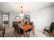 Inviting dining room featuring a wood table, comfortable seating, and stylish chandelier, perfect for Gathering gatherings at 7414 S Monroe Ct, Centennial, CO 80122