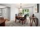 Elegant dining room with a wooden table, six chairs, and bright window at 7414 S Monroe Ct, Centennial, CO 80122