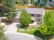 Charming two-story home featuring well-kept landscaping, a driveway, and mature trees at 7414 S Monroe Ct, Centennial, CO 80122