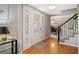 Inviting foyer featuring hardwood floors, decorative front door and staircase at 7414 S Monroe Ct, Centennial, CO 80122