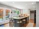 Spacious kitchen featuring an island with seating, granite countertops, and a seamless transition to the outdoor patio at 7414 S Monroe Ct, Centennial, CO 80122