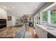 Open kitchen with granite countertops, stainless steel appliances, and a view into the cozy living room with a fireplace at 7414 S Monroe Ct, Centennial, CO 80122